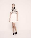 Ivory dress with the black frill on the neck.